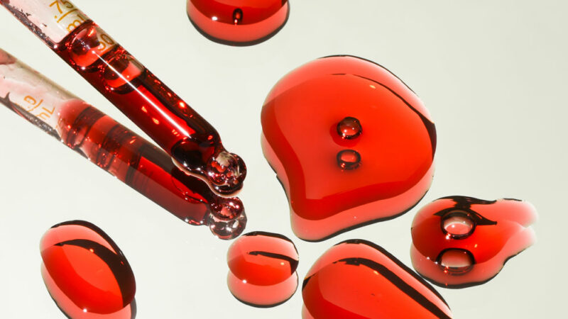 More About Us - Red liquid drops and droppers